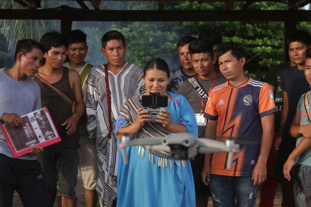 A drone training session takes place with communities in the Amazon rainforest.