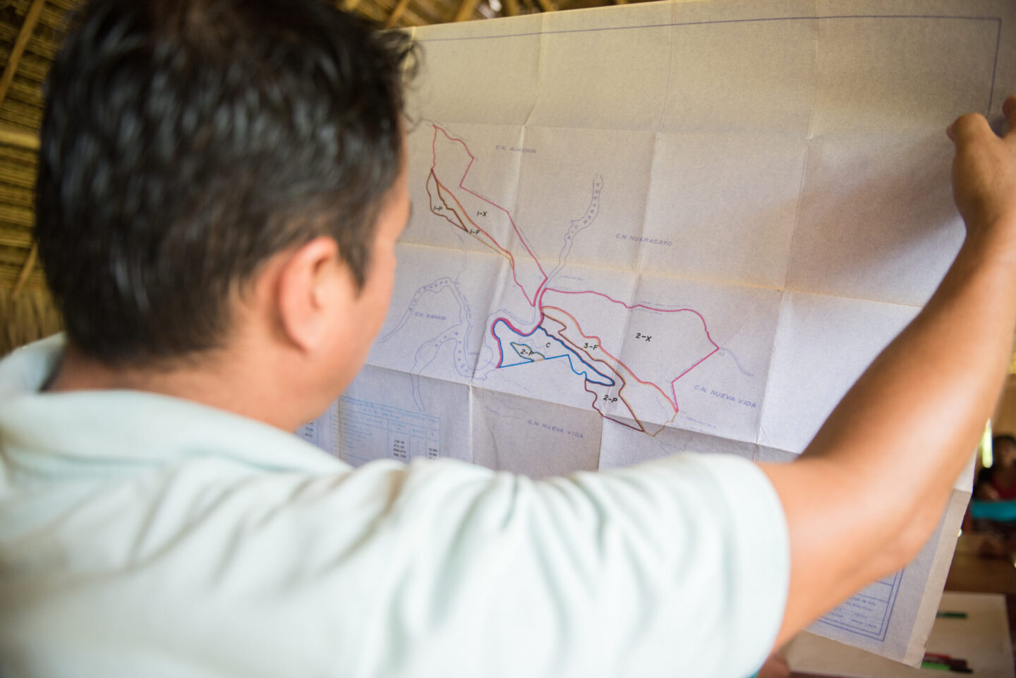A team member looking closely at a large map