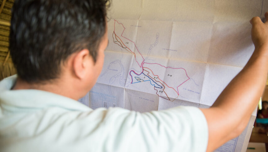 A team member looking closely at a large map